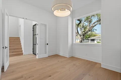 a view of entryway and hall with wooden floor