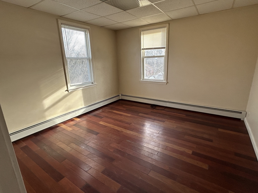 7 Wingate Street Shrewsbury, MA 01545 - Photo 12 of 21 an empty room with wooden floor and windows