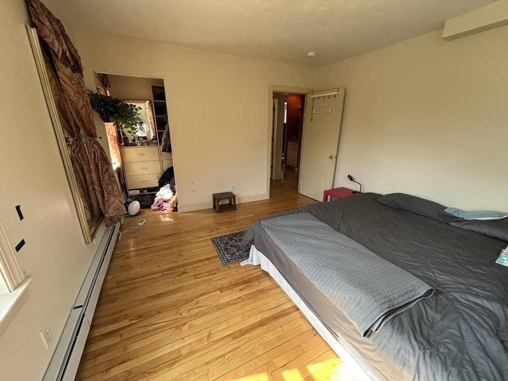 7 Wingate Street Shrewsbury, MA 01545 - Photo 13 of 21 a bed sitting in a bedroom next to a window