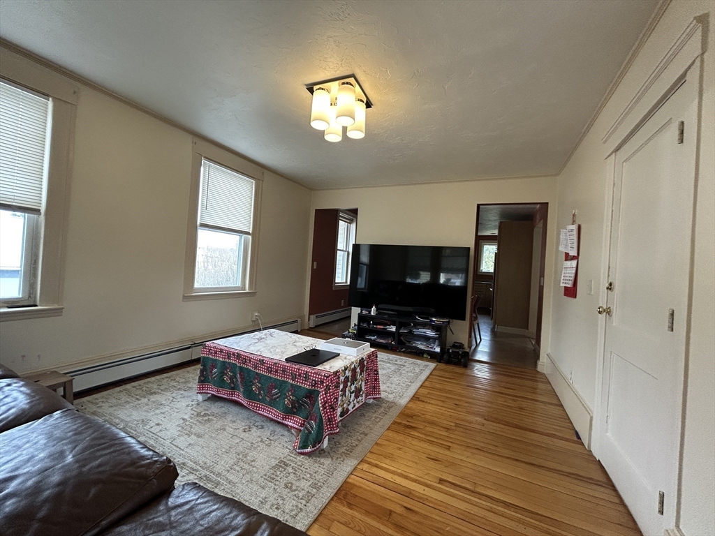 7 Wingate Street Shrewsbury, MA 01545 - Photo 2 of 21 a living room with furniture and a flat screen tv