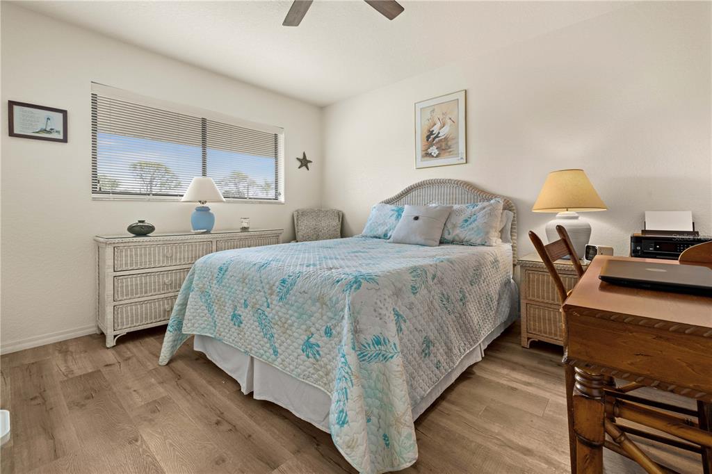 4260 Placida Road, Unit 14C Englewood, FL 34224 - Photo 17 of 37 a bedroom with a bed and a chandelier