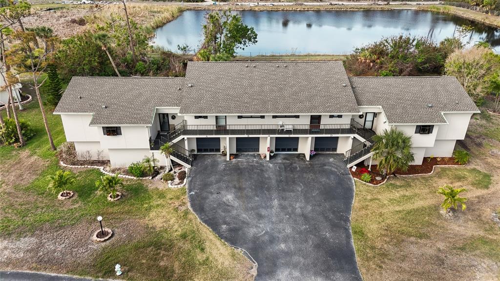 4260 Placida Road, Unit 14C Englewood, FL 34224 - Photo 2 of 37 an aerial view of a house with a yard