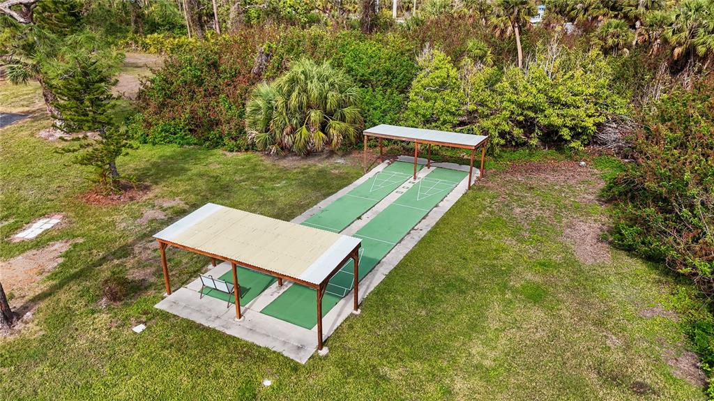 4260 Placida Road, Unit 14C Englewood, FL 34224 - Photo 30 of 37 a view of a backyard with a bench sitting area