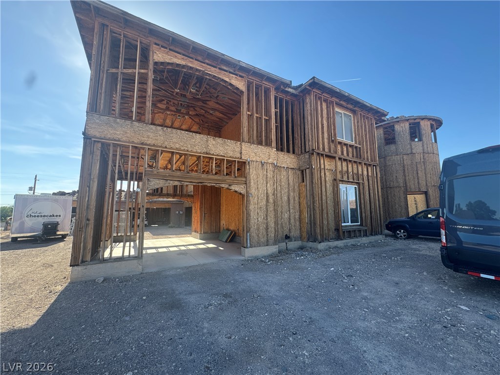 622 North Parawan Street Henderson, NV 89015 - Photo 3 of 3 Under-construction residence, offering a dynamic silhouette against the clear sky, promises a distinctive future dwelling.