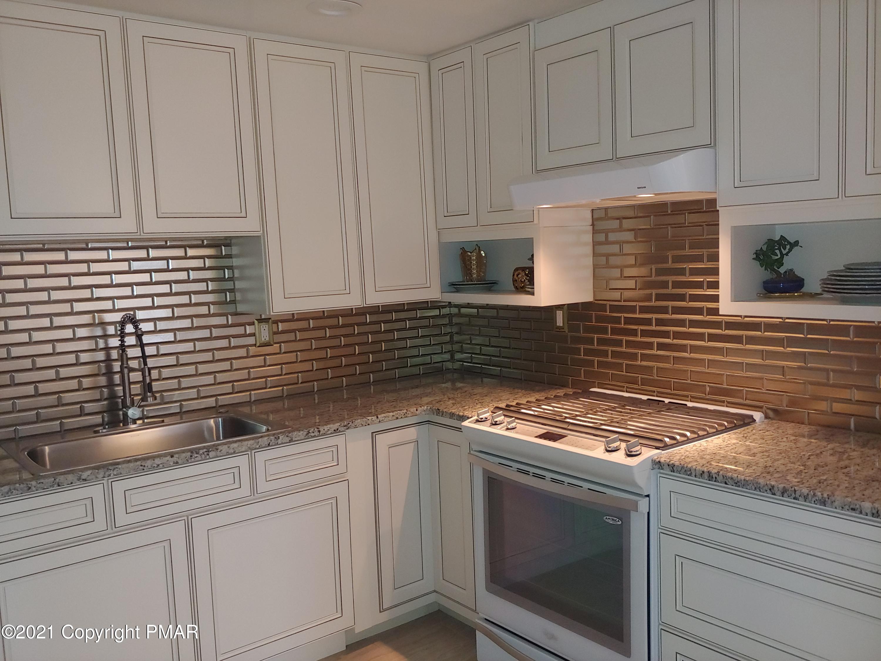 516 Red Rock Road Cresco, PA 18326 - Photo 14 of 47 a kitchen with granite countertop white cabinets and white appliances