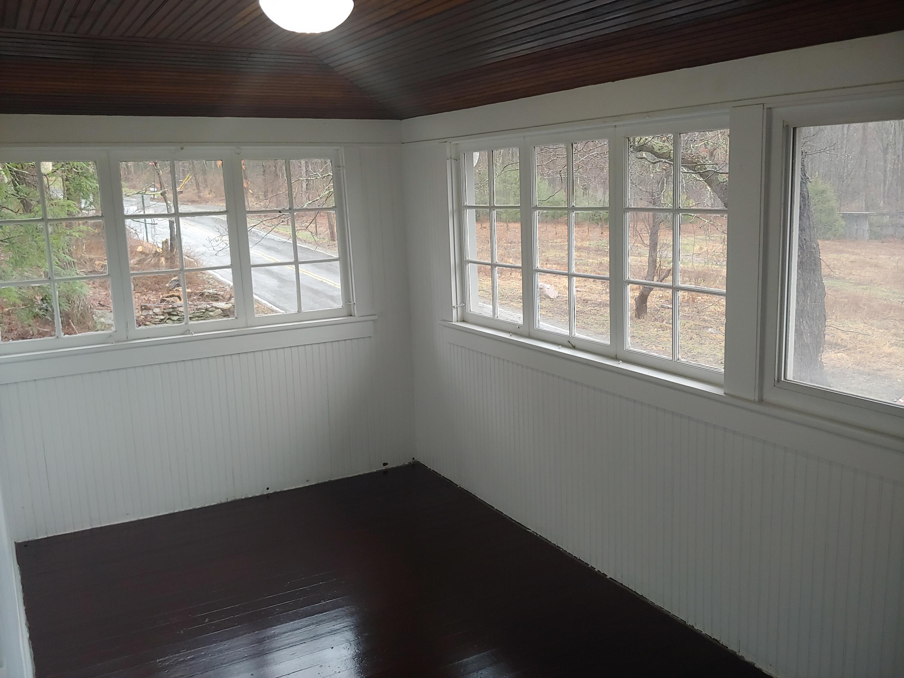516 Red Rock Road Cresco, PA 18326 - Photo 38 of 47 an empty room with wooden floor and windows