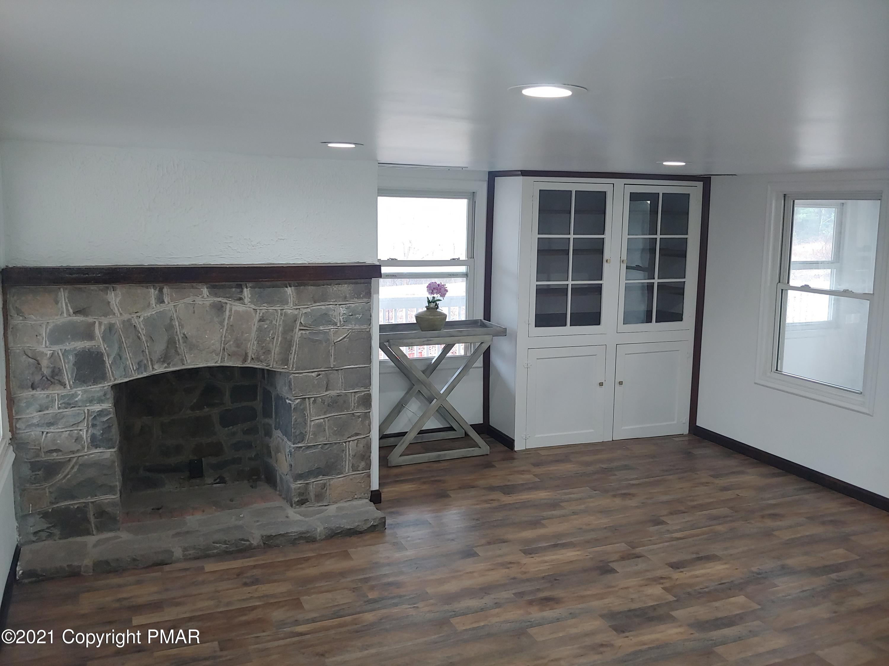 516 Red Rock Road Cresco, PA 18326 - Photo 4 of 47 a living room with furniture and a fireplace