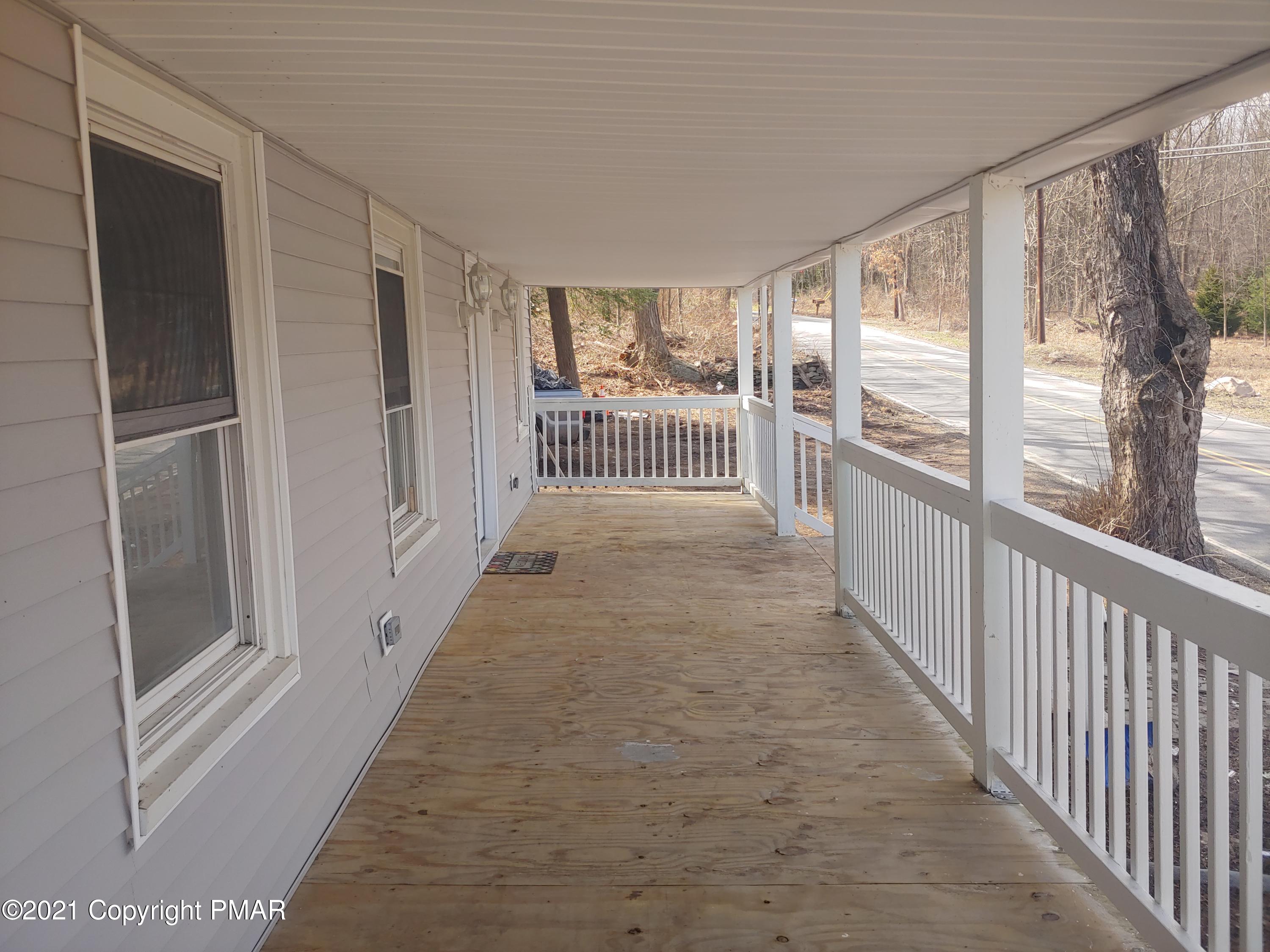516 Red Rock Road Cresco, PA 18326 - Photo 47 of 47 a view of a hallway with wooden floor and a balcony