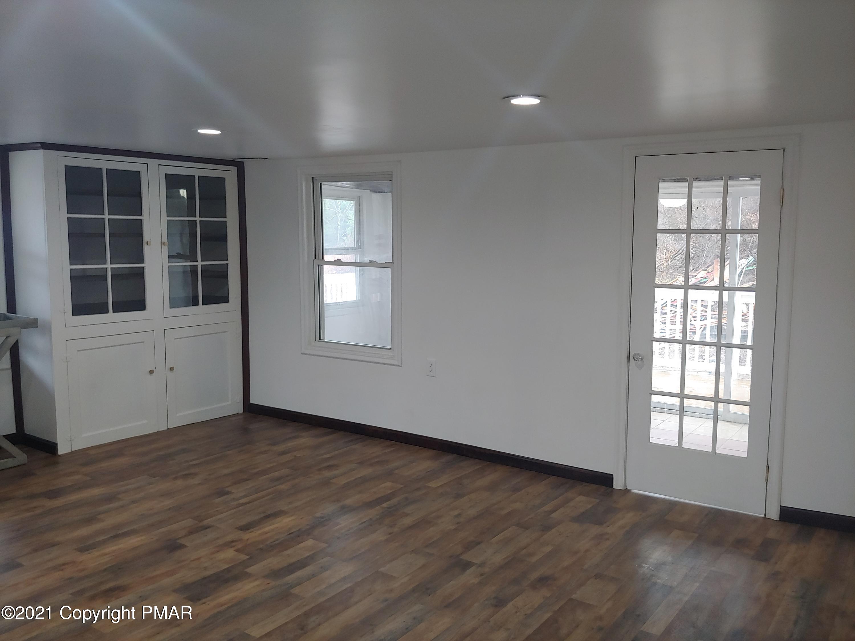 516 Red Rock Road Cresco, PA 18326 - Photo 5 of 47 an empty room with wooden floor and windows