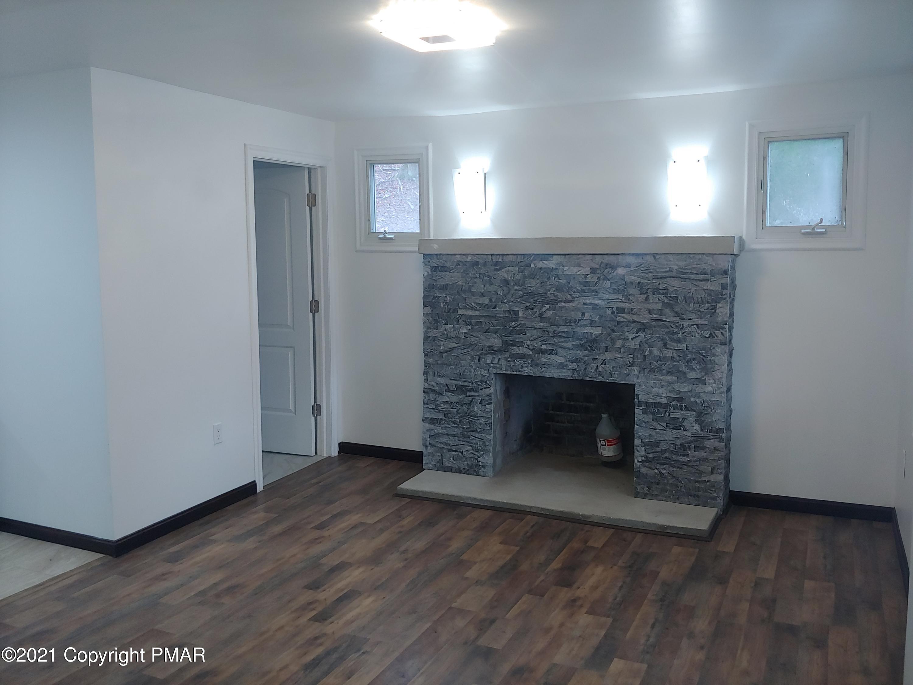 516 Red Rock Road Cresco, PA 18326 - Photo 7 of 47 a room with a fireplace and a fireplace