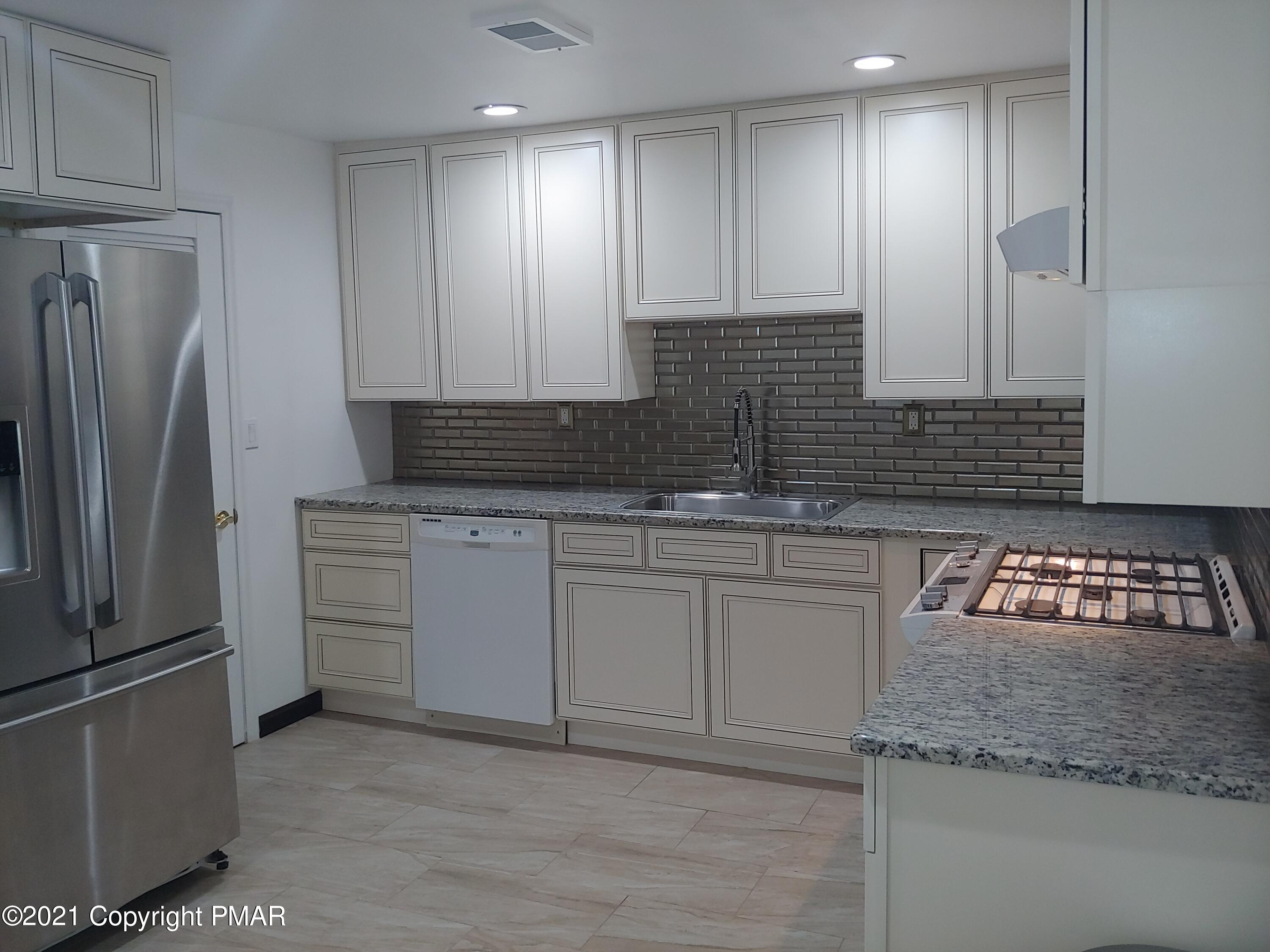 516 Red Rock Road Cresco, PA 18326 - Photo 9 of 47 a kitchen with stainless steel appliances granite countertop a refrigerator and a stove