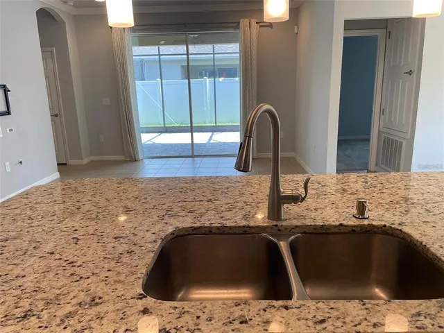 a kitchen with granite countertop a toilet and a sink