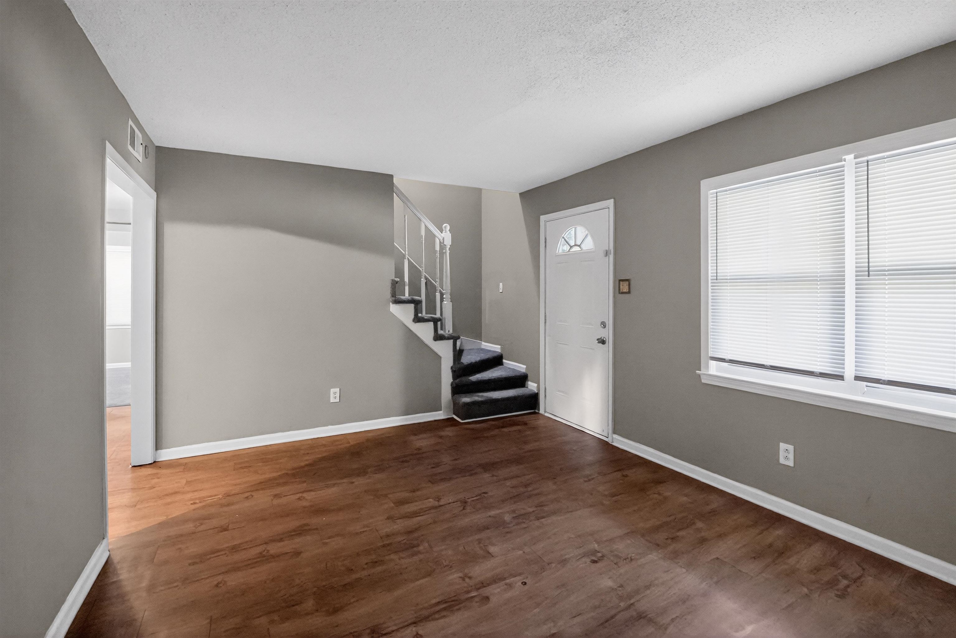 5124 Gill Road Memphis, TN 38109 - Photo 13 of 33 Spacious interior featuring wood-finish flooring, neutral gray wall paint, and white trim