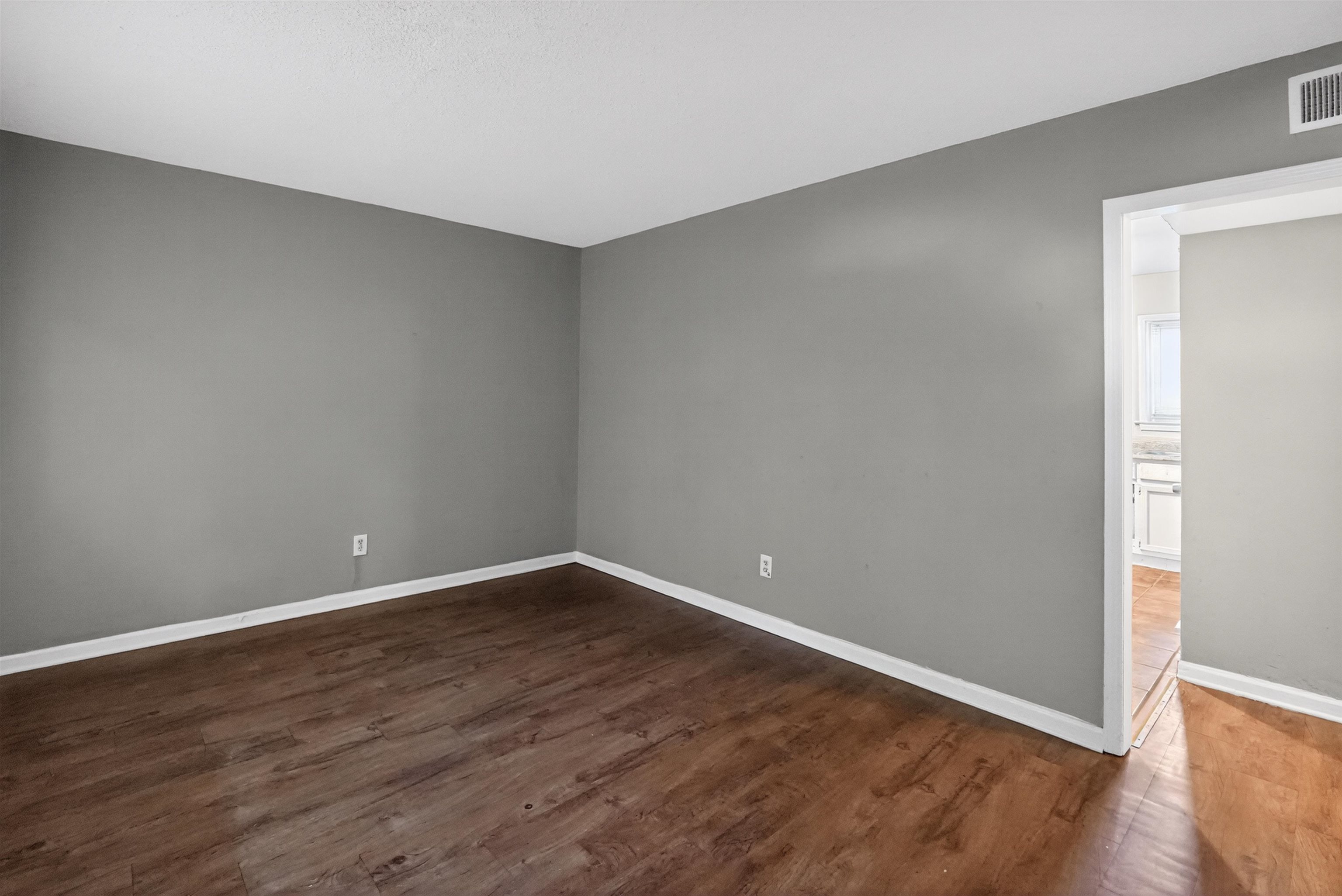 5124 Gill Road Memphis, TN 38109 - Photo 16 of 33 Open concept room featuring wood-finish flooring, light gray wall paint, and white baseboards