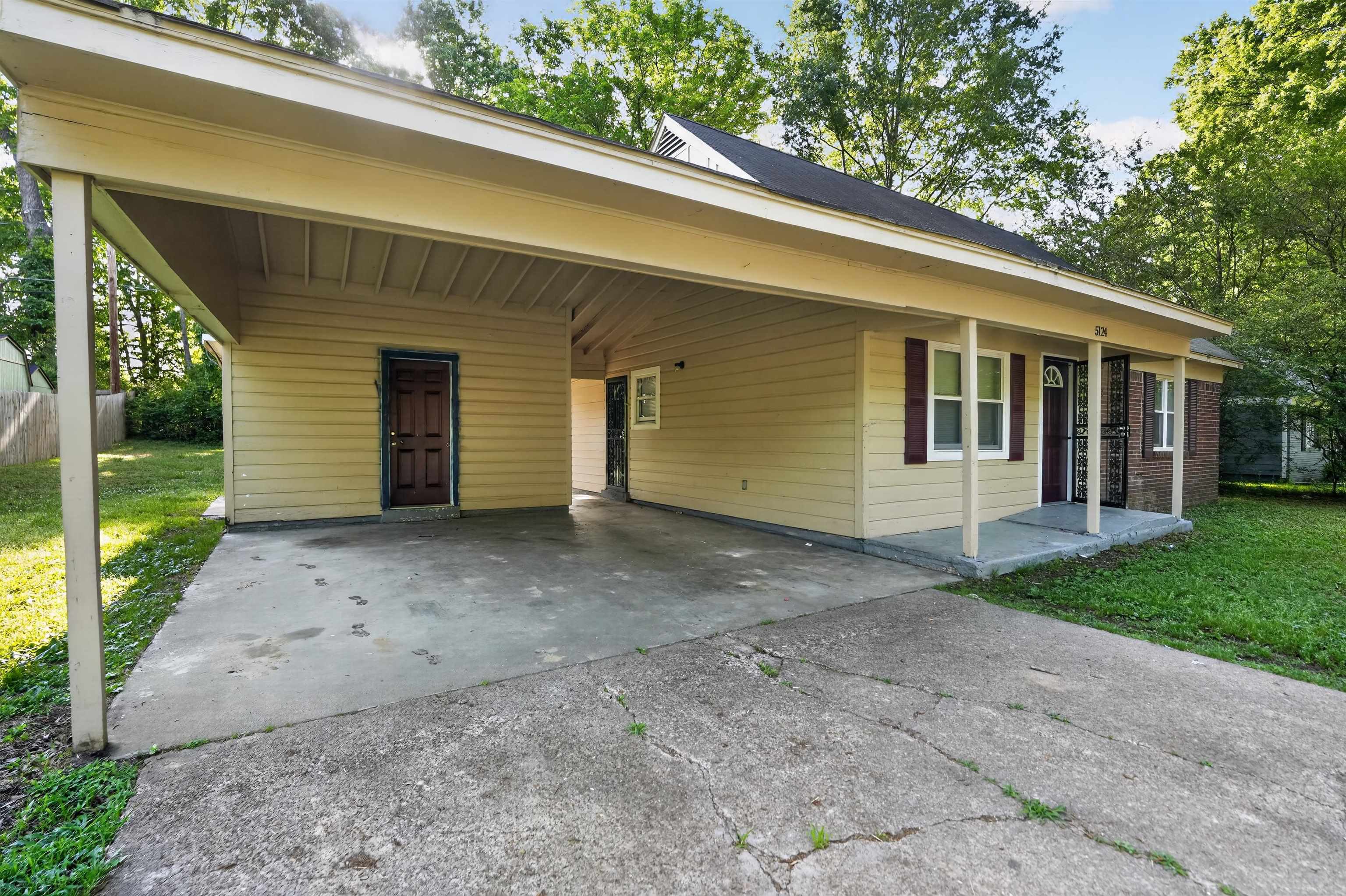 5124 Gill Road Memphis, TN 38109 - Photo 2 of 33 Exterior featuring a covered carport, concrete driveway, and a front porch