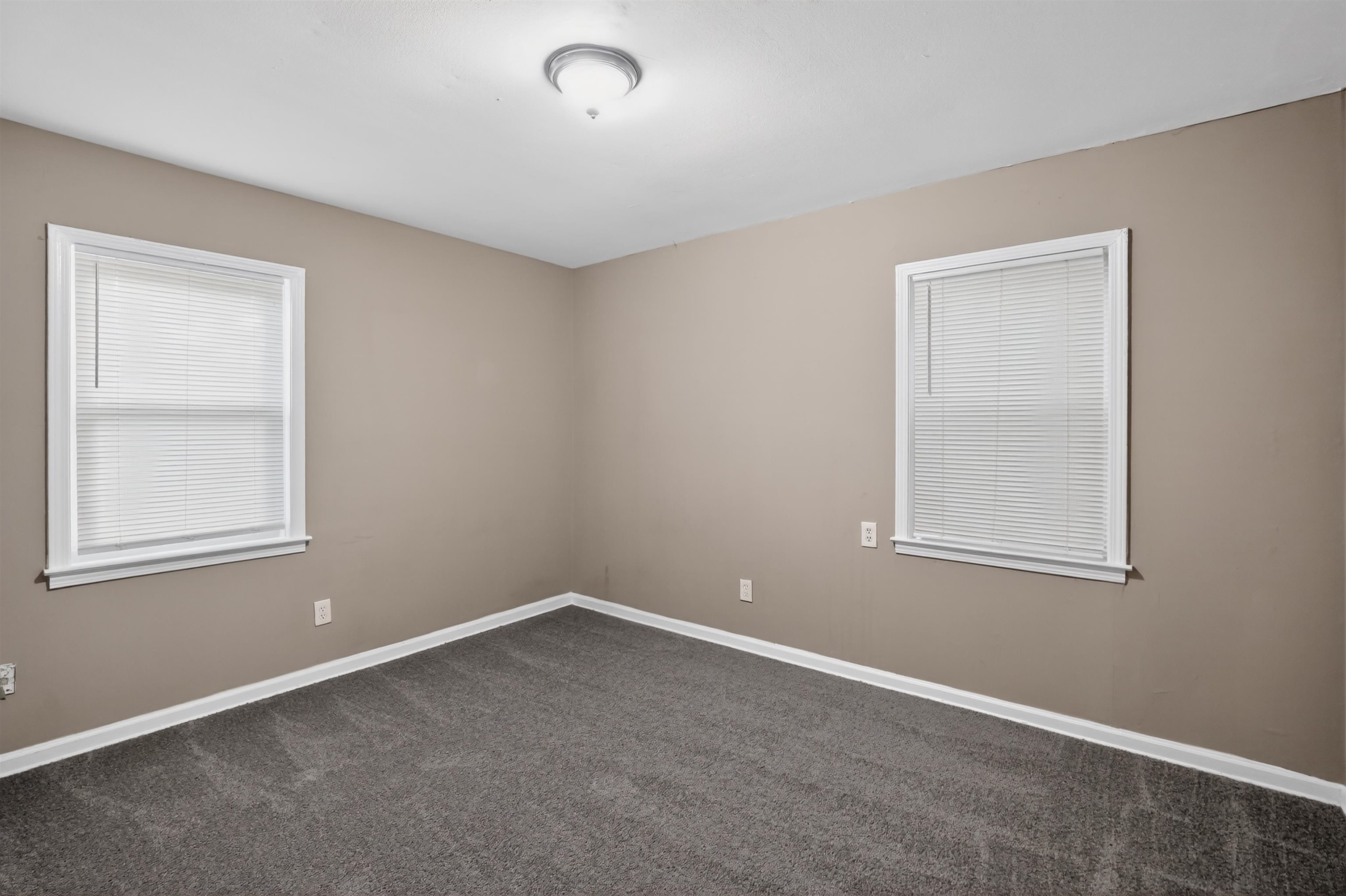 5124 Gill Road Memphis, TN 38109 - Photo 23 of 33 Neutral-toned walls complement the gray carpeting