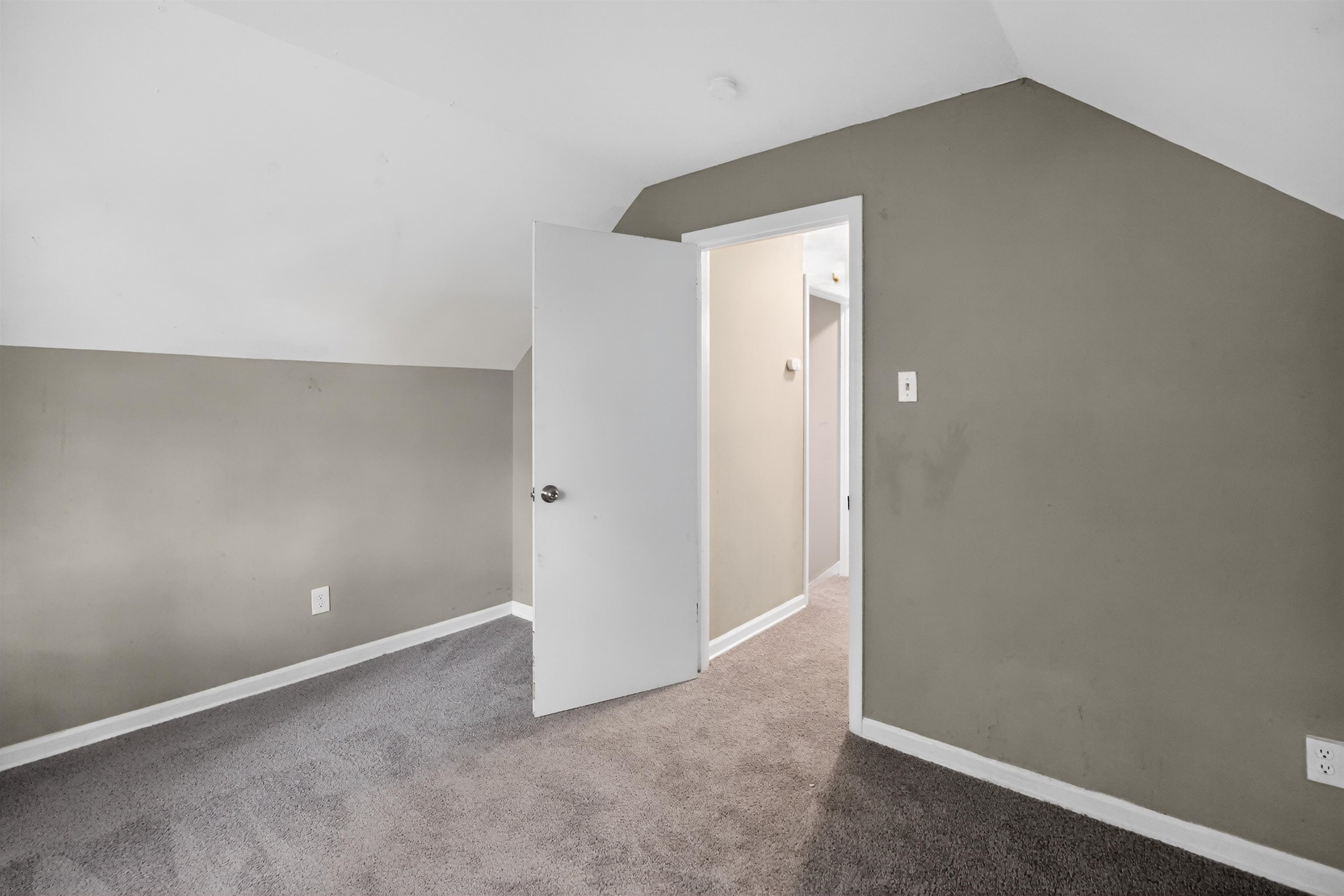 5124 Gill Road Memphis, TN 38109 - Photo 30 of 33 Carpeted interior space with sloped ceilings and neutral wall paint