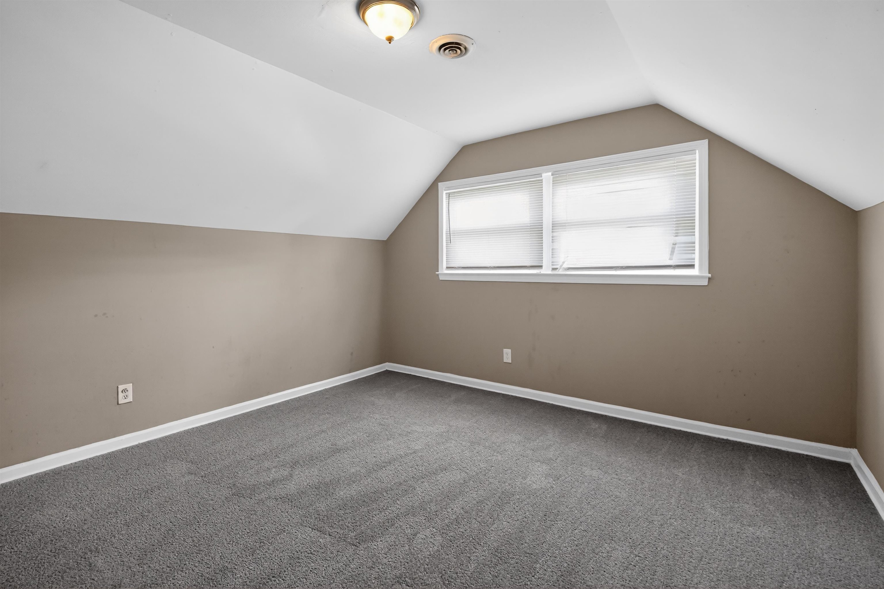 5124 Gill Road Memphis, TN 38109 - Photo 32 of 33 Attic room with sloped ceilings, neutral wall paint, and gray carpet flooring