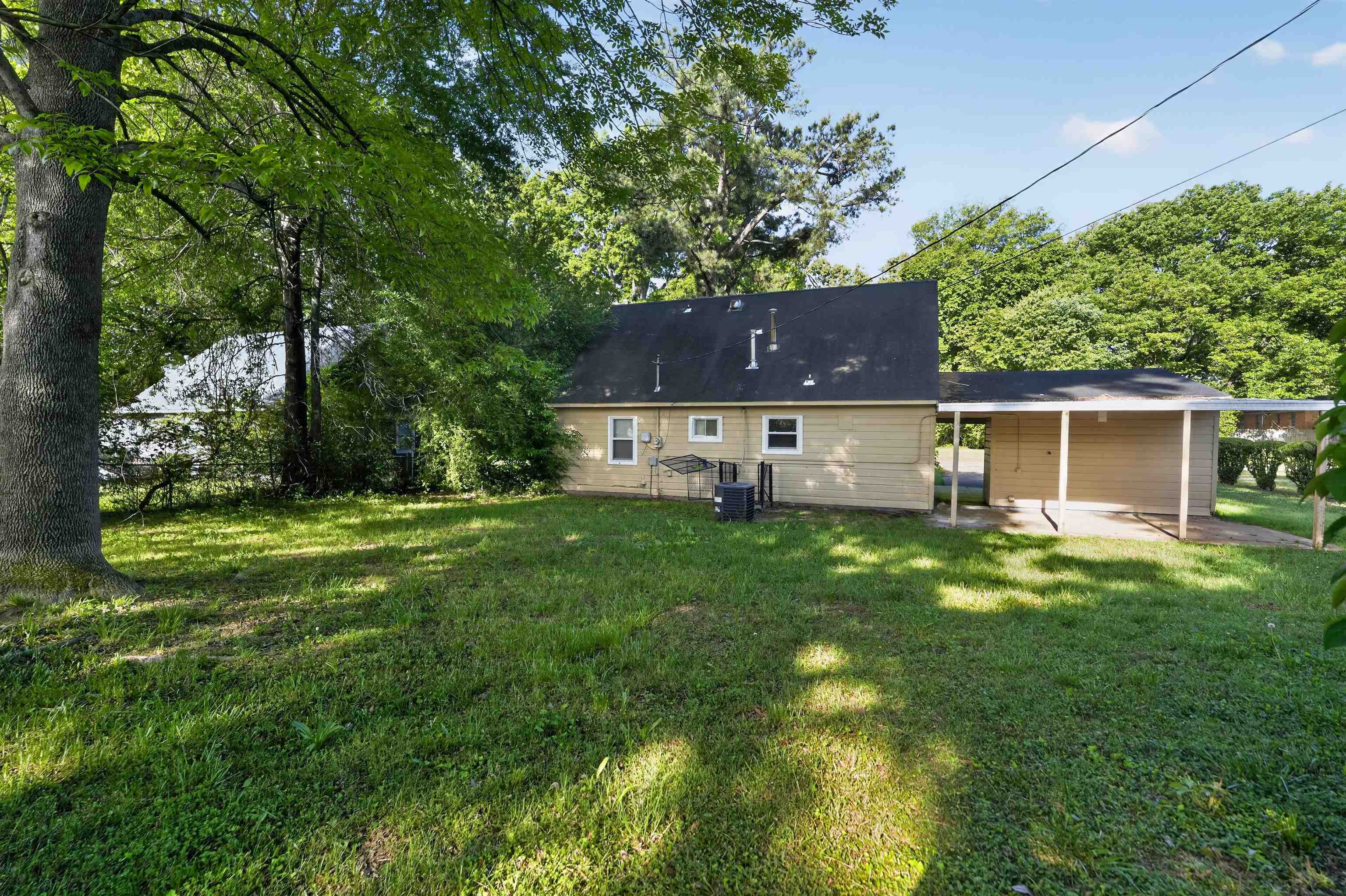 5124 Gill Road Memphis, TN 38109 - Photo 6 of 33 Rear exterior with tan siding and dark shingle roofing