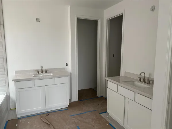 a bathroom with a granite countertop sink a toilet and bathtub