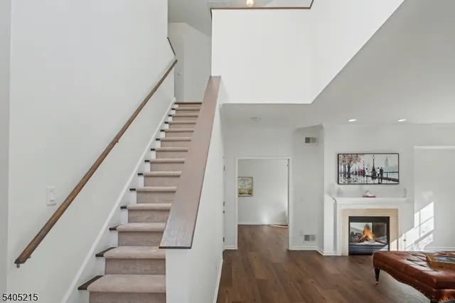 a view of a livingroom with wooden floor and a fireplace