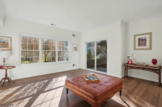 a living room with furniture and next to a window