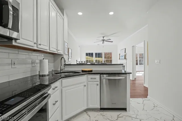 a kitchen with stainless steel appliances granite countertop a sink and cabinets