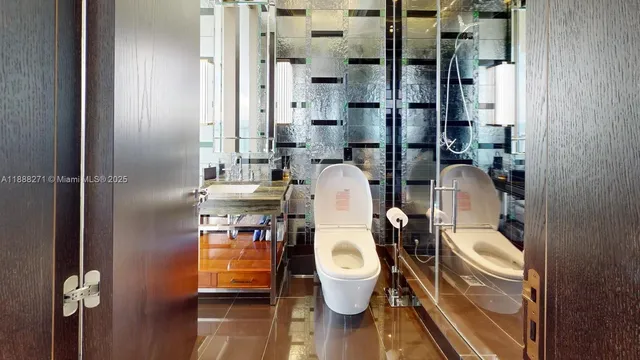 a bathroom with a sink a toilet and mirror