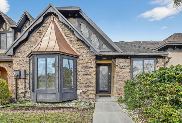 a view of a brick house with a large windows
