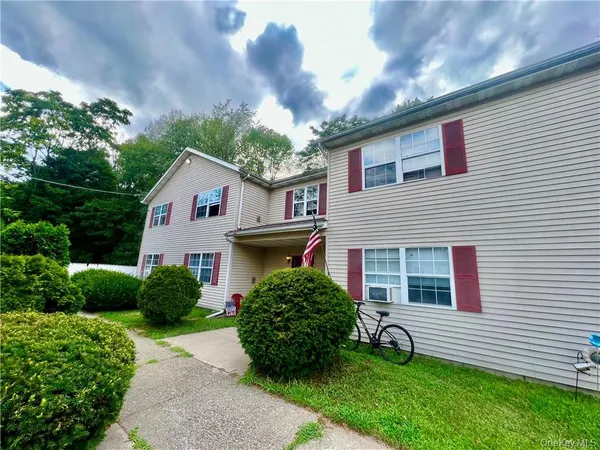 a view of a house with a yard and plants