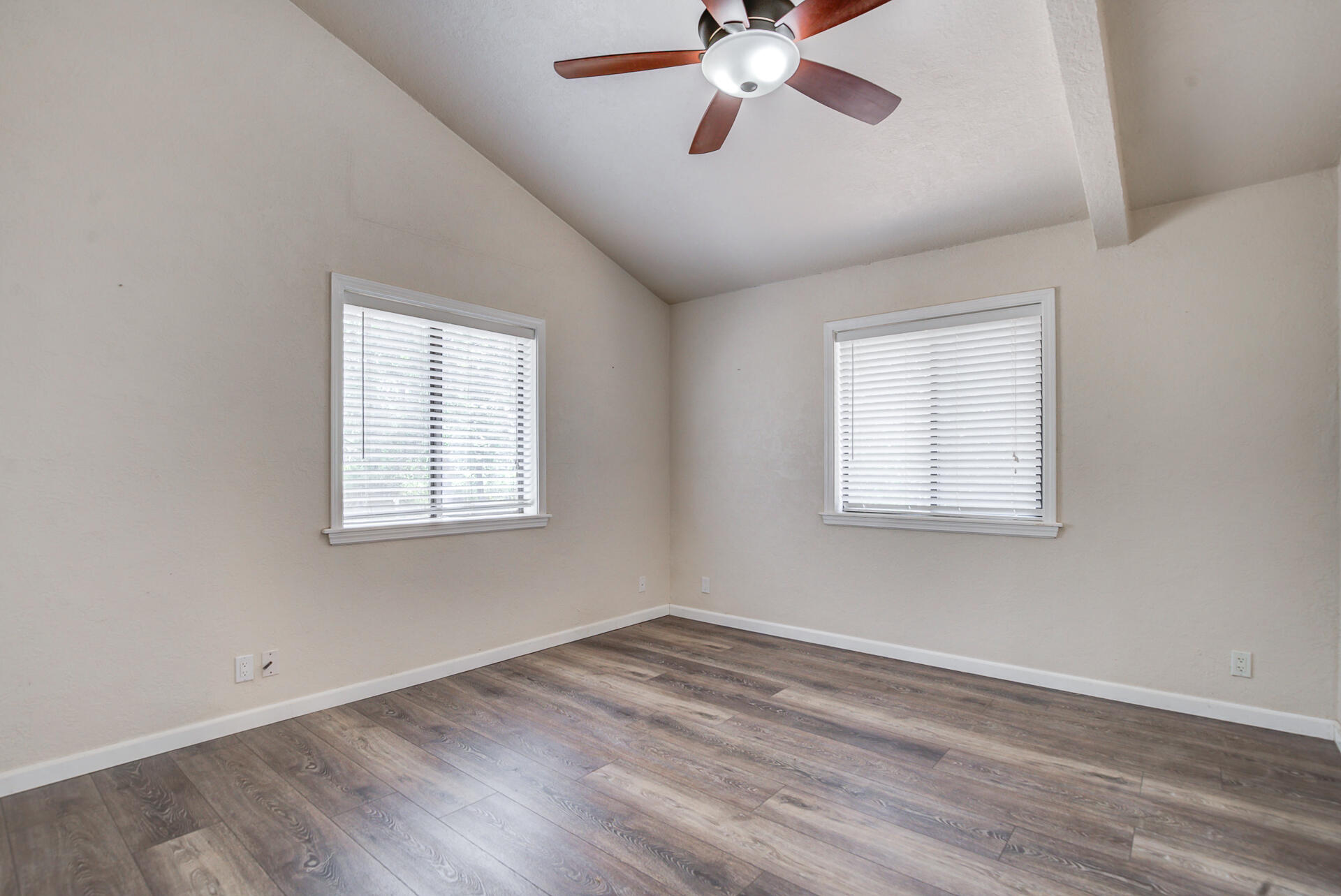 18080 Benson Road Cottonwood, CA 96022 - Photo 34 of 54 an empty room with a window and a chandelier fan