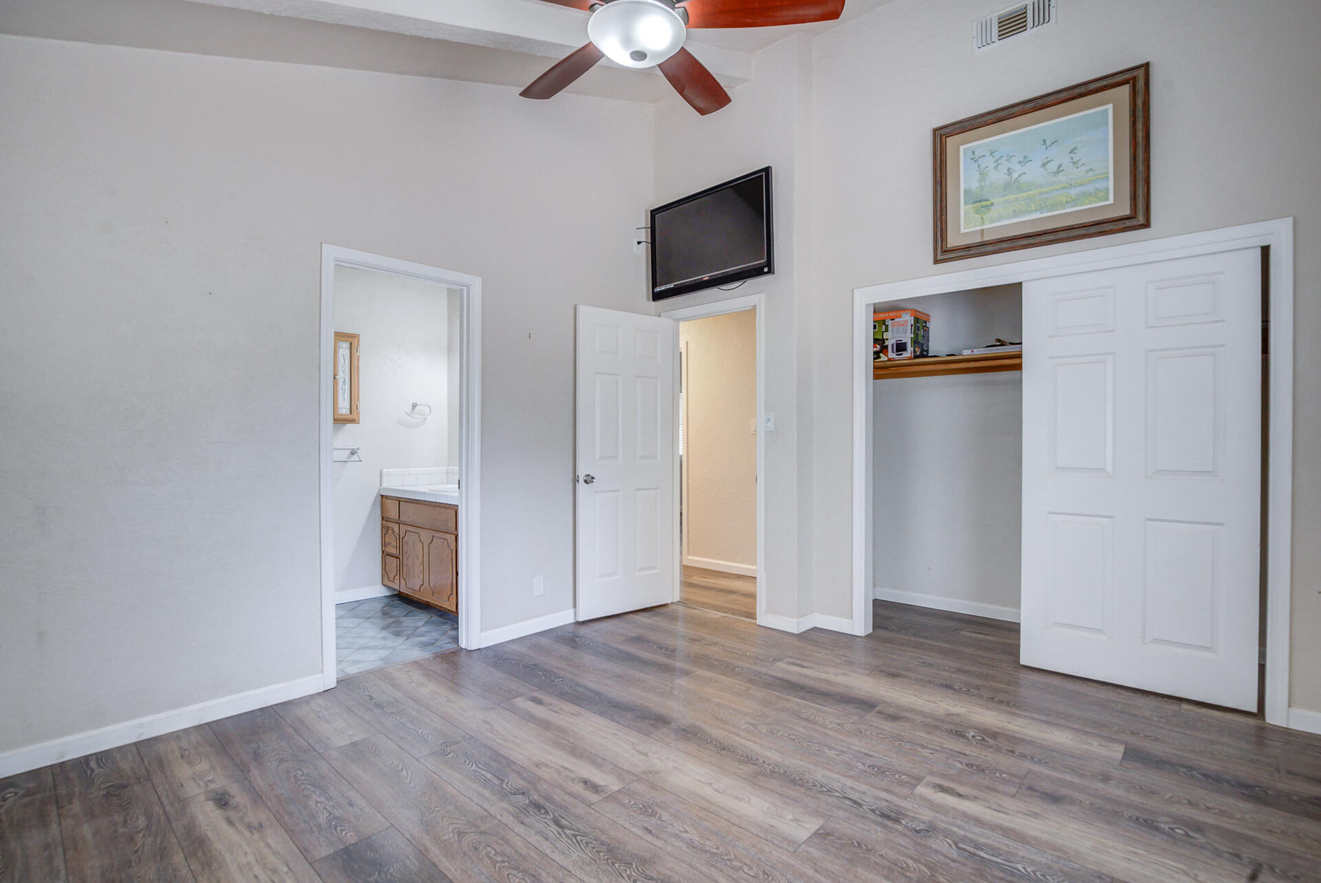 18080 Benson Road Cottonwood, CA 96022 - Photo 35 of 54 a view of a livingroom with wooden floor and a flat screen tv