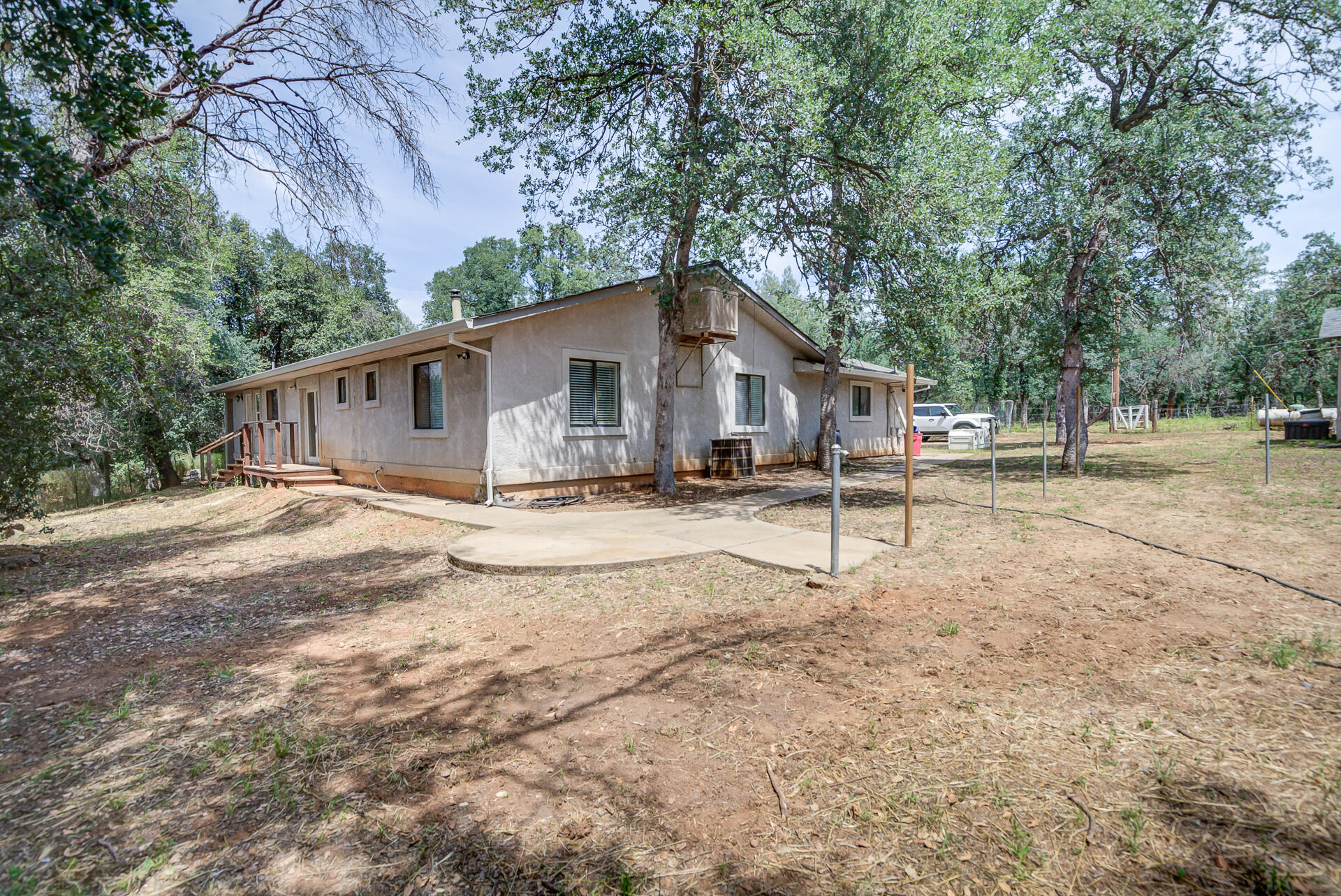 18080 Benson Road Cottonwood, CA 96022 - Photo 42 of 54 a white house that has a tree in front of it