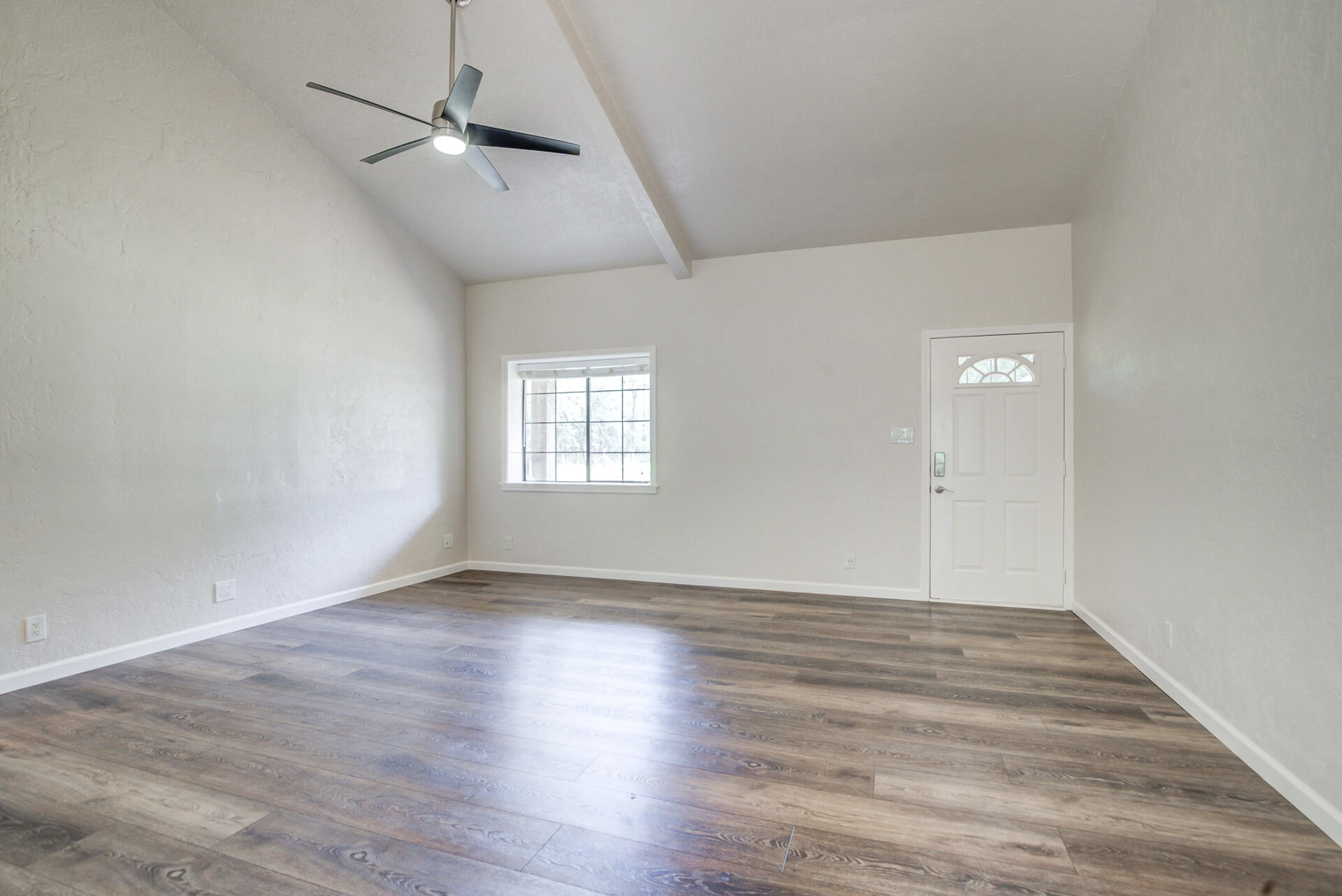 18080 Benson Road Cottonwood, CA 96022 - Photo 9 of 54 a view of an empty room with wooden floor and a window