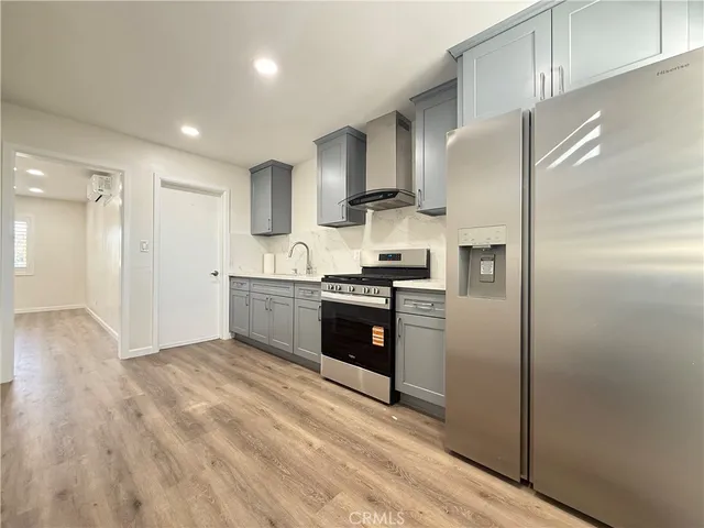 a kitchen with stainless steel appliances a refrigerator and a sink