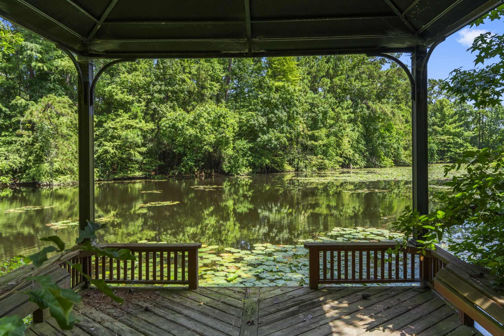426 Nursery Road The Woodlands, TX 77380 - Photo 31 of 41 Custom deck with built-in benches, roof on beautiful pond.