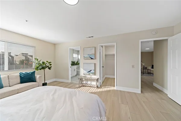 a bedroom with a bed and a couch