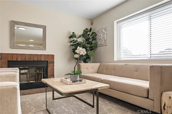 a living room with furniture and a fireplace