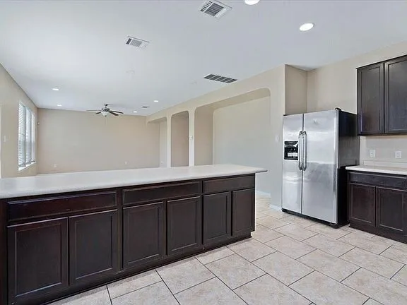 a kitchen with granite countertop a refrigerator and a sink