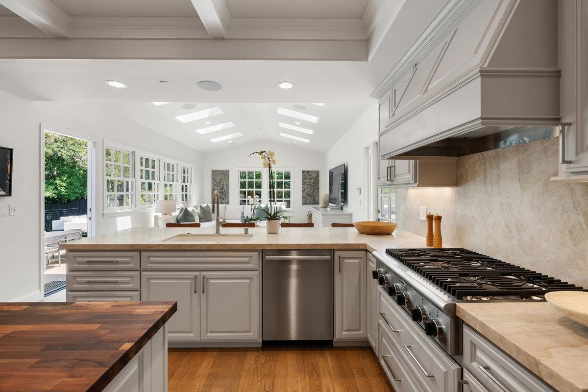 130 Stonehedge Road Hillsborough, CA 94010 - Photo 12 of 32 a kitchen with stainless steel appliances a sink stove and cabinets