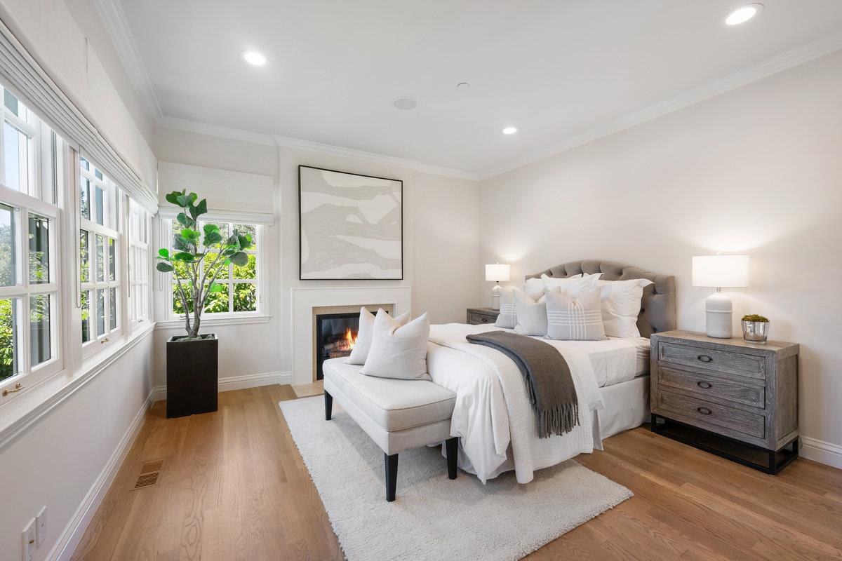 130 Stonehedge Road Hillsborough, CA 94010 - Photo 17 of 32 a spacious bedroom with a bed a couch and a large window with outer view