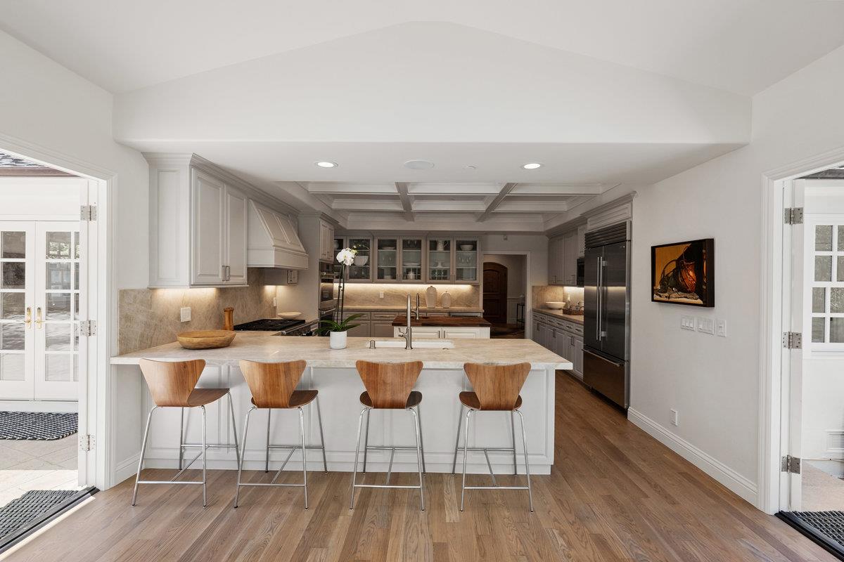 130 Stonehedge Road Hillsborough, CA 94010 - Photo 8 of 32 a view of a dining room with furniture a kitchen and chandelier