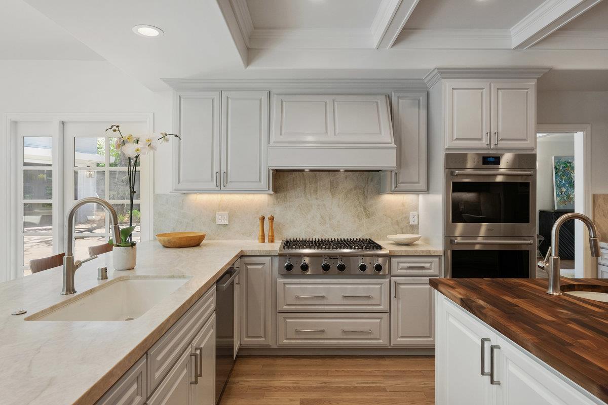 130 Stonehedge Road Hillsborough, CA 94010 - Photo 9 of 32 a kitchen with stainless steel appliances granite countertop a sink stove and refrigerator