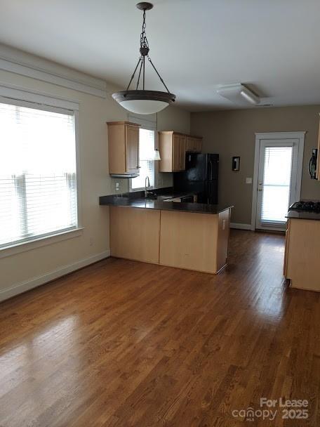16535 Knox Run Road Huntersville, NC 28078 - Photo 3 of 15 a kitchen with stainless steel appliances granite countertop a sink a microwave cabinets and wooden floor