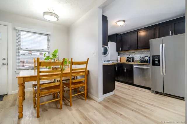 a kitchen with stainless steel appliances kitchen island granite countertop a refrigerator and a stove top oven