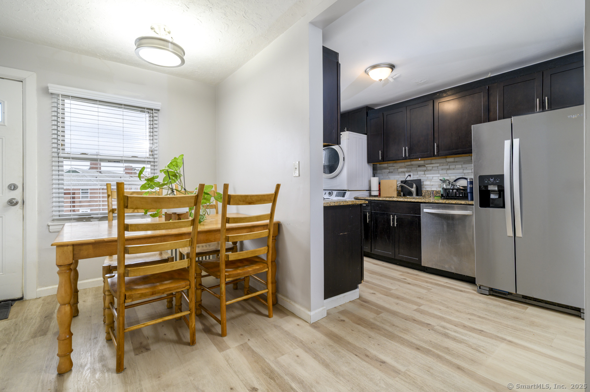1046 East Main Street, Unit 4 Stamford, CT 06902 - Photo 2 of 11 a kitchen with stainless steel appliances kitchen island granite countertop a refrigerator and a stove top oven