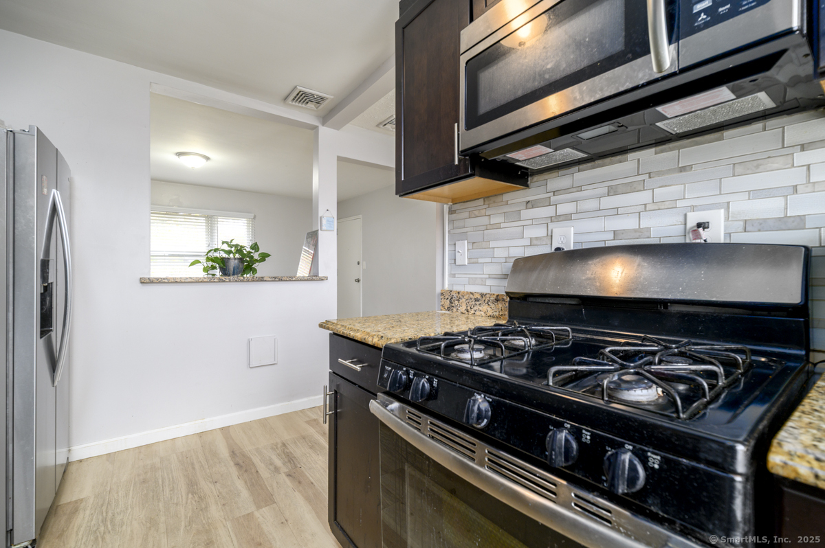 1046 East Main Street, Unit 4 Stamford, CT 06902 - Photo 5 of 11 a stove top oven sitting inside of a kitchen