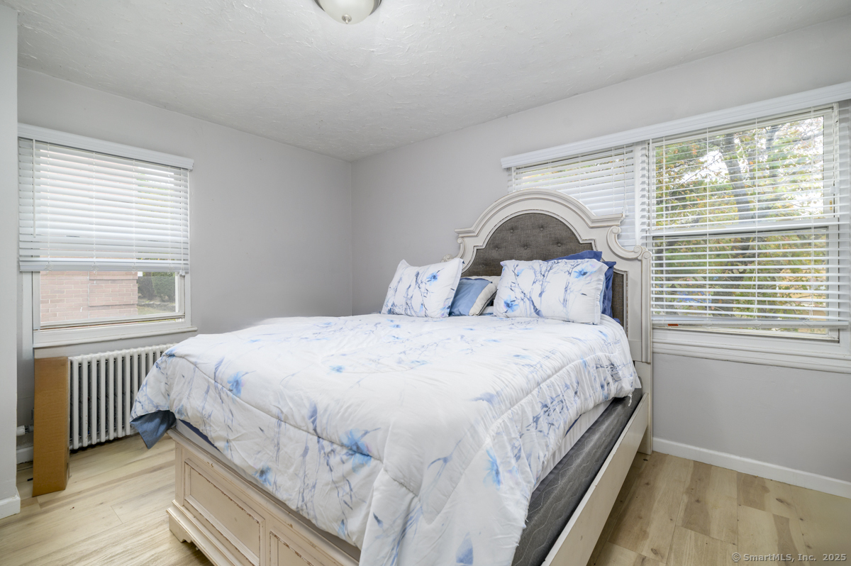 1046 East Main Street, Unit 4 Stamford, CT 06902 - Photo 9 of 11 a bedroom with a bed and a window