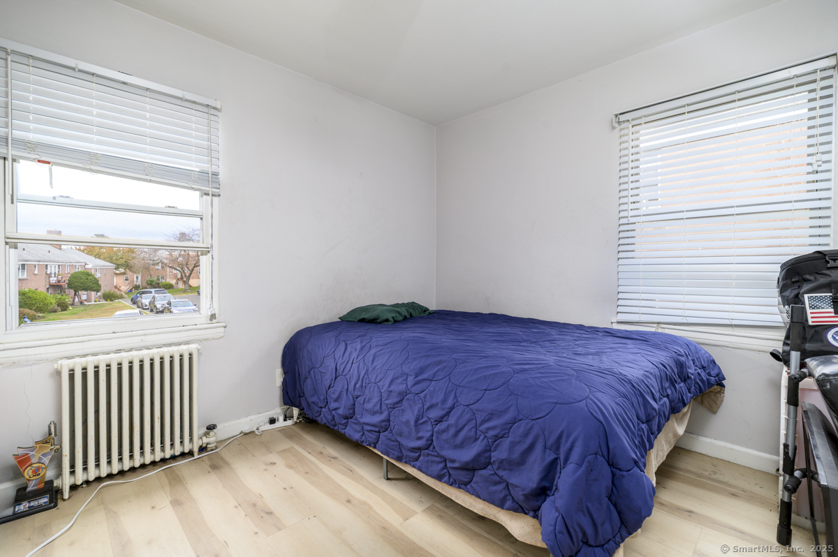 1046 East Main Street, Unit 4 Stamford, CT 06902 - Photo 10 of 11 a bedroom with a bed and a window