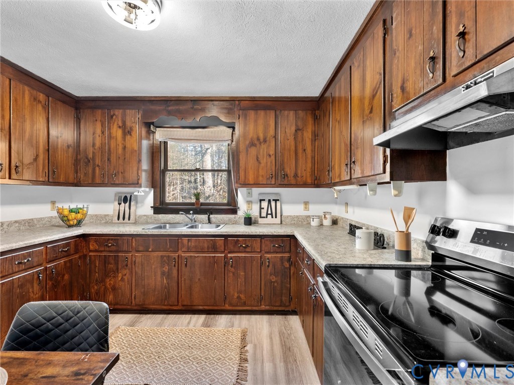 4905 Old Buckingham Road Powhatan, VA 23139 - Photo 12 of 50 a kitchen with a sink stove top oven and cabinets